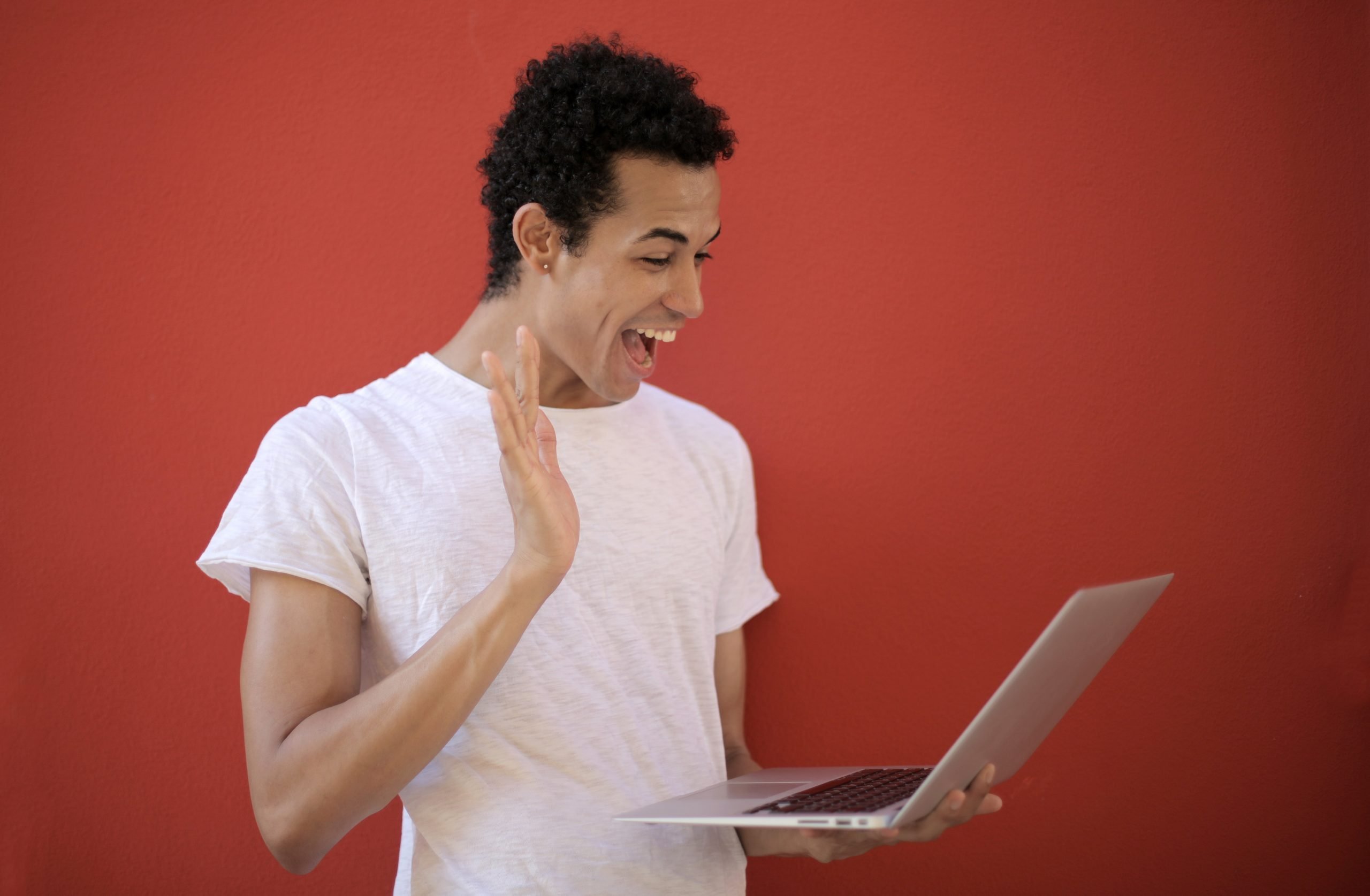 Image of happy person holding laptop computer waving hi to his LifeRing ePal