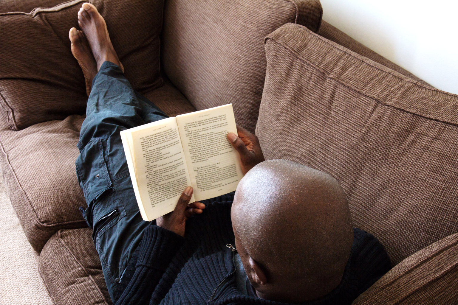 Image of man reading LifeRing Book on couch